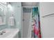Cozy bathroom with a shower featuring a flamingo-themed shower curtain at 1210 N Waccamaw Dr. # 1008, Garden City Beach, SC 29576