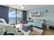 Comfortable living room featuring ocean views from the large balcony doors at 1210 N Waccamaw Dr. # 1008, Garden City Beach, SC 29576