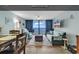 Inviting living room with new flooring and a wall of windows showcasing ocean views at 1210 N Waccamaw Dr. # 1008, Garden City Beach, SC 29576