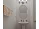 Half-bath featuring pedestal sink, oval mirror, and brushed nickel fixtures at 1249 Shoebridge Dr. # 1249, Myrtle Beach, SC 29579