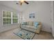 Bright bedroom with a striped sofa, matching throw pillows, area rug, and a large window for plenty of sunlight at 1249 Shoebridge Dr. # 1249, Myrtle Beach, SC 29579