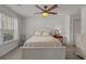 Bright bedroom with ceiling fan, white furniture, and a comfortable floral comforter at 1249 Shoebridge Dr. # 1249, Myrtle Beach, SC 29579