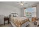 Comfortable bedroom with a decorative wrought iron bed, ceiling fan, and natural light from the window at 1249 Shoebridge Dr. # 1249, Myrtle Beach, SC 29579