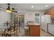 Bright eat-in kitchen featuring a breakfast bar, white appliances, and sliding glass doors to the patio at 1249 Shoebridge Dr. # 1249, Myrtle Beach, SC 29579