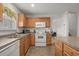 Bright kitchen with warm cabinets, double sink, full appliances, and view into other rooms at 1249 Shoebridge Dr. # 1249, Myrtle Beach, SC 29579