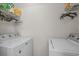 Convenient laundry area with modern washer and dryer units and storage shelving at 1249 Shoebridge Dr. # 1249, Myrtle Beach, SC 29579