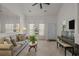 Spacious living room with a large sofa, complemented by a decorative mirror and natural light at 1249 Shoebridge Dr. # 1249, Myrtle Beach, SC 29579