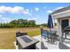 Covered patio with outdoor furniture, offering relaxation overlooking the backyard at 1396 Highway 129, Galivants Ferry, SC 29544