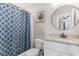 Well-lit bathroom featuring a granite countertop vanity, modern fixtures, and decorative shower curtain at 1396 Highway 129, Galivants Ferry, SC 29544