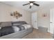 Cozy bedroom with a ceiling fan, modern wall art and a comfortable gray daybed at 1396 Highway 129, Galivants Ferry, SC 29544