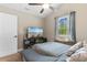 Bright bedroom featuring a ceiling fan, a TV and a comfortable gray bed set at 1396 Highway 129, Galivants Ferry, SC 29544