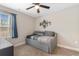 Light-filled bedroom with a ceiling fan, modern wall art, and a cozy gray daybed at 1396 Highway 129, Galivants Ferry, SC 29544