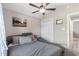 This bedroom has a unique gray bed with a ceiling fan and neutral walls at 1396 Highway 129, Galivants Ferry, SC 29544