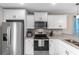 Bright kitchen featuring white cabinetry, stainless steel appliances, and stylish countertops at 1396 Highway 129, Galivants Ferry, SC 29544