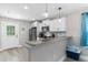 Open kitchen with white cabinets, stainless steel appliances, and granite breakfast bar at 1396 Highway 129, Galivants Ferry, SC 29544
