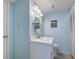 Bathroom featuring a white vanity, a round mirror, and a louvered door at 1500 Cenith Dr. # D 103, North Myrtle Beach, SC 29582