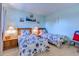 Bright bedroom featuring matching twin beds adorned with nautical themed bedding and light blue walls at 1500 Cenith Dr. # D 103, North Myrtle Beach, SC 29582