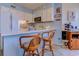 Bright kitchen featuring white cabinets, modern appliances, and a cozy breakfast bar at 1500 Cenith Dr. # D 103, North Myrtle Beach, SC 29582
