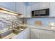 Updated kitchen with sleek appliances, a mosaic backsplash and a double sink at 1500 Cenith Dr. # D 103, North Myrtle Beach, SC 29582