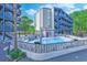 Exterior of building features an inviting fenced pool area with multiple lounge chairs at 1500 Cenith Dr. # D 103, North Myrtle Beach, SC 29582