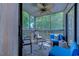 Relaxing screened porch with multiple seating arrangements and ceiling fan for comfort at 1500 Cenith Dr. # D 103, North Myrtle Beach, SC 29582