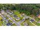 Residential home highlighted from an aerial perspective in a neighborhood setting surrounded by mature trees at 1505 Bramber Pl., Conway, SC 29527