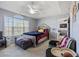 This bedroom includes carpet flooring, a ceiling fan, and large window. It offers access to the connected living room at 1505 Bramber Pl., Conway, SC 29527