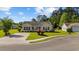 Inviting single-story home featuring a well-maintained lawn, mature landscaping, and a cozy front porch at 1505 Bramber Pl., Conway, SC 29527