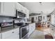 Kitchen featuring white cabinets, stainless steel appliances, and an open view of an adjacent dining area at 1505 Bramber Pl., Conway, SC 29527