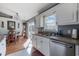 Bright kitchen featuring white cabinets, stainless steel appliances, and natural light from a window and sliding glass door at 1505 Bramber Pl., Conway, SC 29527
