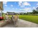 Outdoor patio with a dining set overlooking a spacious, green backyard at 1505 Bramber Pl., Conway, SC 29527