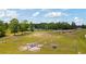 Sprawling horse property with fencing, stables, and mature trees, a perfect equestrian setting at 151 Saddle Dr., Loris, SC 29569