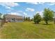 Spacious backyard featuring a well-maintained lawn, fenced area and a house with a back porch at 151 Saddle Dr., Loris, SC 29569