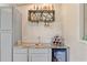 A contemporary bar area with a built-in wine cooler, copper sink, and decorative shelving for liquor bottles at 151 Saddle Dr., Loris, SC 29569