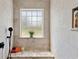 Luxurious bathroom featuring marble walls and flooring, a built-in shower bench, a rainfall shower head, and frosted window at 151 Saddle Dr., Loris, SC 29569
