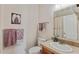 Well-lit bathroom featuring a toilet, sink, mirror, and towel rack with decorative purple towels at 151 Saddle Dr., Loris, SC 29569