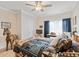 Cozy bedroom features a ceiling fan, wood accents, rustic decor, and a comfortable bed with decorative pillows at 151 Saddle Dr., Loris, SC 29569