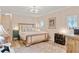 Bright bedroom features a neutral color palette, a stylish chandelier, and light wood floors at 151 Saddle Dr., Loris, SC 29569