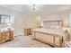Bright bedroom features a neutral color palette, a stylish chandelier, and a comfortable bed with decorative pillows at 151 Saddle Dr., Loris, SC 29569