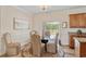 Elegant dining room featuring hardwood floors, a glass table with upholstered chairs, and a sliding door with natural light at 151 Saddle Dr., Loris, SC 29569