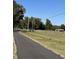 Driveway leading to a property with fenced pastures and outbuildings at 151 Saddle Dr., Loris, SC 29569
