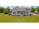Charming single-Gathering home with a well-manicured lawn, gray siding, a covered front porch, and turquoise shutters at 151 Saddle Dr., Loris, SC 29569