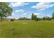 Expansive front yard with lush green grass and a horse carriage at 151 Saddle Dr., Loris, SC 29569