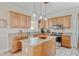 Well-lit kitchen featuring granite countertops, a kitchen island, stainless steel appliances, and light wood cabinets at 151 Saddle Dr., Loris, SC 29569