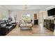 A contemporary living room features hardwood floors, neutral walls, and a plush leather sofa with a decorative horse on the coffee table at 151 Saddle Dr., Loris, SC 29569