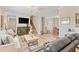 Open-concept living space with a staircase, hardwood floors, a leather sofa, and neutral walls at 151 Saddle Dr., Loris, SC 29569