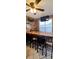 Features a bar with custom wood counter, shelves, decor, TV, and bar stools at 1717 Perdiz Covey Ct., Myrtle Beach, SC 29588