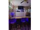 Entertaining bar area with wood countertop, stocked shelves, seating, and mounted TV at 1717 Perdiz Covey Ct., Myrtle Beach, SC 29588