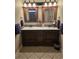 Bathroom with double sinks, granite countertop, framed mirrors, tile floors, and ample storage at 1717 Perdiz Covey Ct., Myrtle Beach, SC 29588