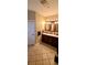 Primary bathroom showcasing a double vanity with a dark wood finish, and tile floors at 1717 Perdiz Covey Ct., Myrtle Beach, SC 29588